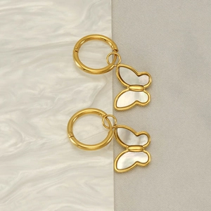 Elegant gold butterfly hoop earrings with mother of pearl inlay on marble background