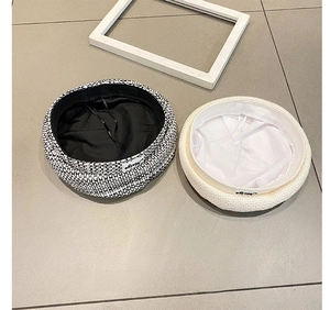 Detailed view of woven beret hats showing inner lining and adjustable drawstring cord