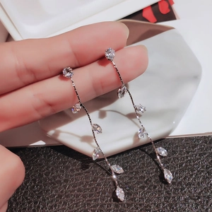 Detailed close-up of zircon leaf tassel earrings showing leaf shapes and long fringe style