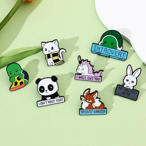 Detailed view of cute animal enamel pins including cat, panda and fox on green background