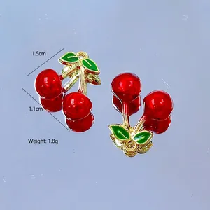 Detail view of cherry pendants with dimensions 1.5cm by 1.1cm and weight 1.8g each