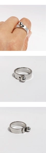 Detailed views of silver geometric ring with spherical clasp on a white background