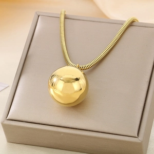 Close-up of 18K gold-plated stainless steel hollow ball pendant on thick snake chain