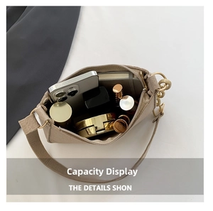 Interior view showing the storage capacity for phone, lipstick and cosmetics in khaki felt bag