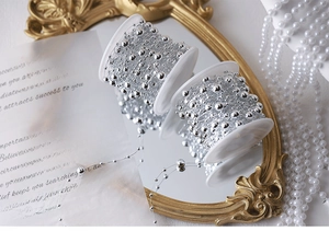 Detail of silver bead chain rolls with alternating large and small pearls for DIY decor