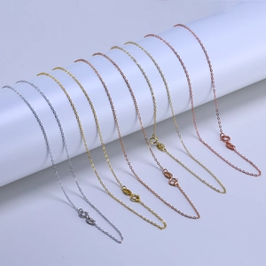 Detailed macro view of thin link chains in silver, gold, and rose gold finishes