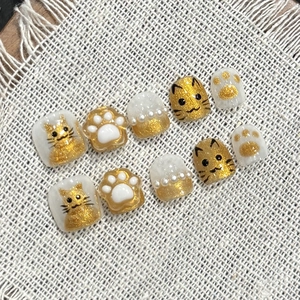 Handmade 3D cat themed press-on nails for kids with gold glitter and pearl accents