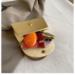 Detail showing internal capacity of gold metal clutch with sparkling rhinestone bottom