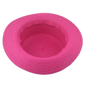 Detail of fuchsia woven straw hat featuring tight spiral texture and sweatband lining