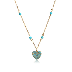 Detailed close-up of golden necklace with heart turquoise pendant and beaded chain accent