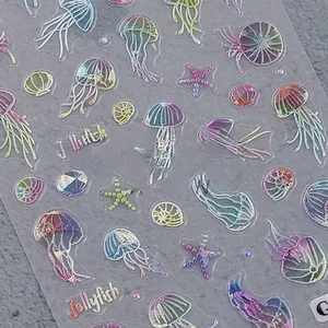Macro detail of 3D embossed ocean theme nail stickers featuring jellyfish and starfish