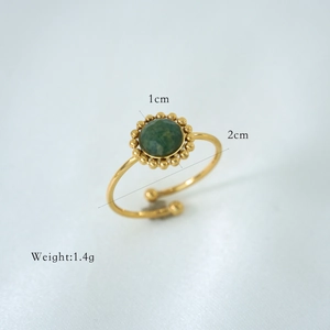 Detail of adjustable gold ring with green natural stone, featuring size and weight markings