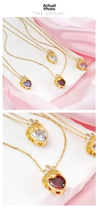 Close-up of heart-shaped gemstone necklaces with gold crown pendants in assorted colors