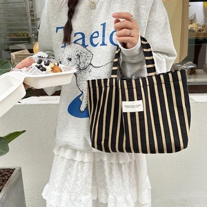 Classic striped canvas tote bag with black and yellow patterns for daily commuting