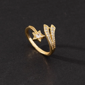 Detail of gold star-shaped open ring featuring micro-pave white zircon settings