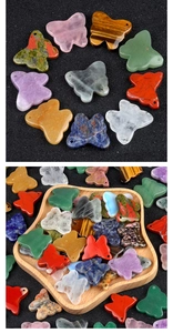 Variety of natural stone butterfly pendants including rose quartz and amethyst displayed in bulk