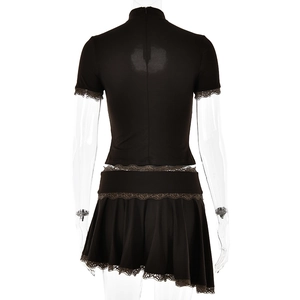 Detail view of black lace trim and asymmetrical pleats on the back of the two-piece set