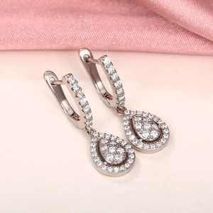 Macro shot of silver drop earrings with AAA cubic zirconia in a pear-shaped design