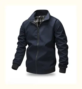 Detail of navy blue jacket featuring a classic plaid lining and elastic ribbed cuffs
