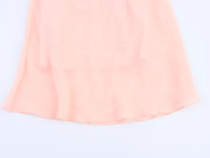 Close-up of pink layered chiffon dress hem showing delicate stitching and sheer fabric