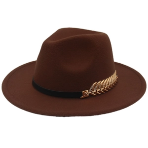 Detail of a brown wide-brim fedora hat featuring a striking gold leaf metal accessory