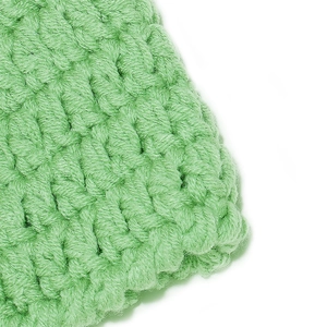 Detailed macro view of green knit octopus hat showing thick handmade crochet textures