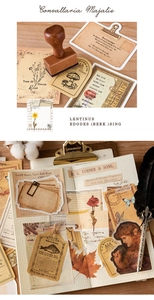 Detail of vintage scrapbooking kit featuring floral labels, paper layers and stamps