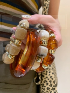 Close-up of vintage acrylic resin bangles with amber and marble texture and metal beads