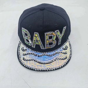 Détail du lettrage BABY en strass colorés et texture crocodile irisée sur la casquette
