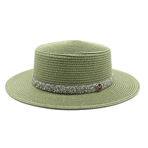 Close-up of moss green boater hat with rhinestone band and metallic M buckle detail