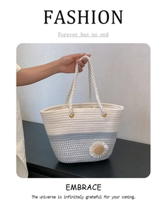 Macro detail of hand-woven cotton rope tote bag with daisy decor and golden metal rings