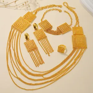 Detailed close-up of gold-plated jewelry set featuring multi-layer tassels and geometric patterns