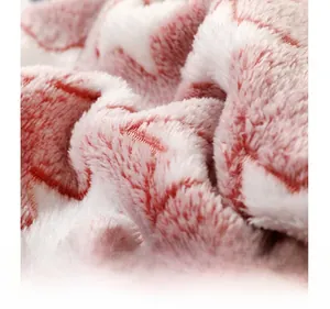 Microscopic detail showing the high-density coral fleece structure of the pink pet blanket