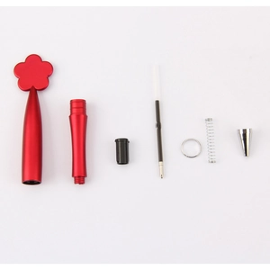 Disassembled parts of a red flower-topped metal ballpoint pen on a white background