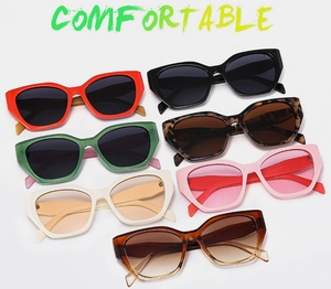 Flat lay of retro cat eye sunglasses in multiple colors including black, red, and leopard