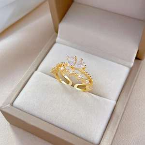 Macro view of adjustable gold butterfly ring with zircon stones in a jewelry box