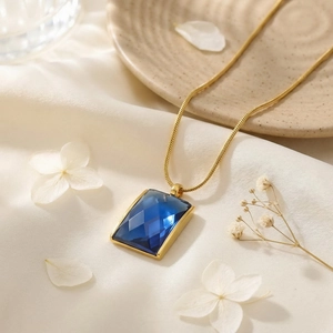Detail of dark blue rectangular gemstone pendant with 18K gold plated snake chain