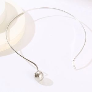 Close-up of a silver minimalist stainless steel choker with a sphere pendant on a prop