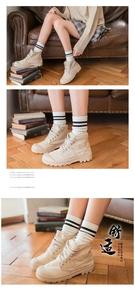 Detail of black and white striped cotton socks paired with beige high-top canvas sneakers