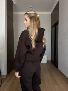 Deep brown oversized hooded sweatshirt and joggers tracksuit set shown from a side view