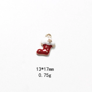 Detail of a red enamel Christmas stocking charm with gold stars and dimensions 13x17mm