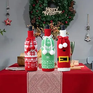 Three-piece knitted Christmas wine bottle covers with snowflake and Santa motifs