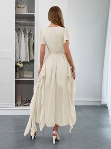 Elegant beige short sleeve maxi dress with waist tie and ruffled hem shown from the back