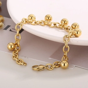 Dettaglio del bracciale a catena con sfere in oro 18K e chiusura a moschettone su piatto