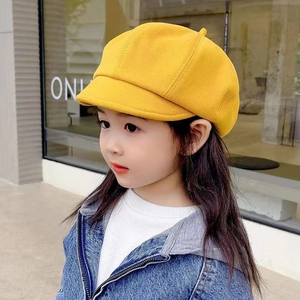 Detail of yellow kids beret hat showing thick fabric and stylish octagonal design