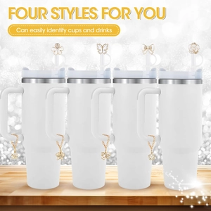 Detail view of four styles of golden rhinestone straw covers with flower and bow charms