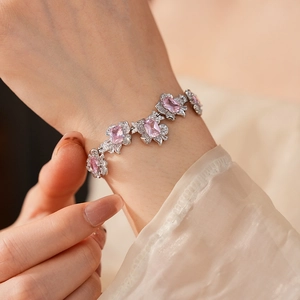Detailed view of silver flower bracelet featuring square-cut pink zircon gemstones