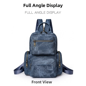Detailed front view of navy blue denim texture backpack with bronze metal zippers