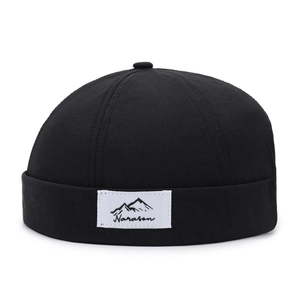 Minimalist black docker cap with mountain logo patch in breathable quick-dry fabric