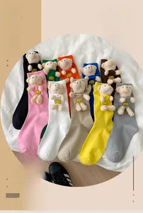 Macro detail of various colorful cotton crew socks featuring cute 3D plush bears
